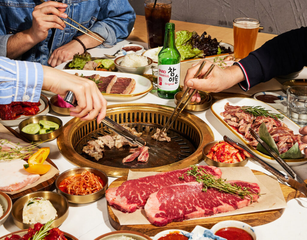 people cooking korean barbeque